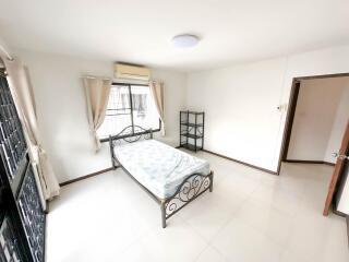 Modern bedroom with metal framed bed, large window