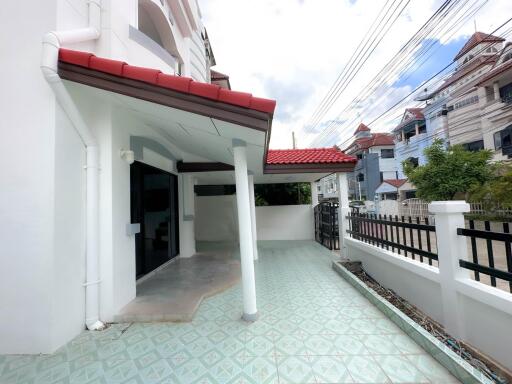 Front porch area of a house with tiled flooring and covered space