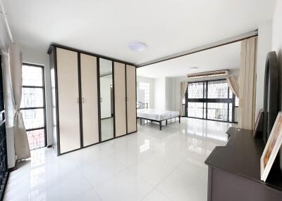 Spacious bedroom with built-in closet and large windows