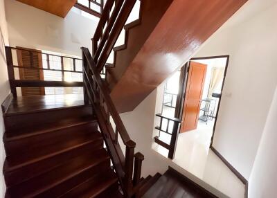 Indoor wooden staircase leading to the upper floor