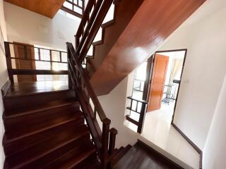 Indoor wooden staircase leading to the upper floor