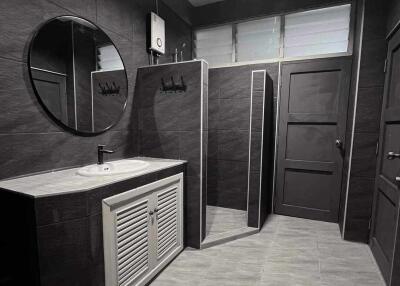 Modern black and white bathroom with spacious shower and vanity unit