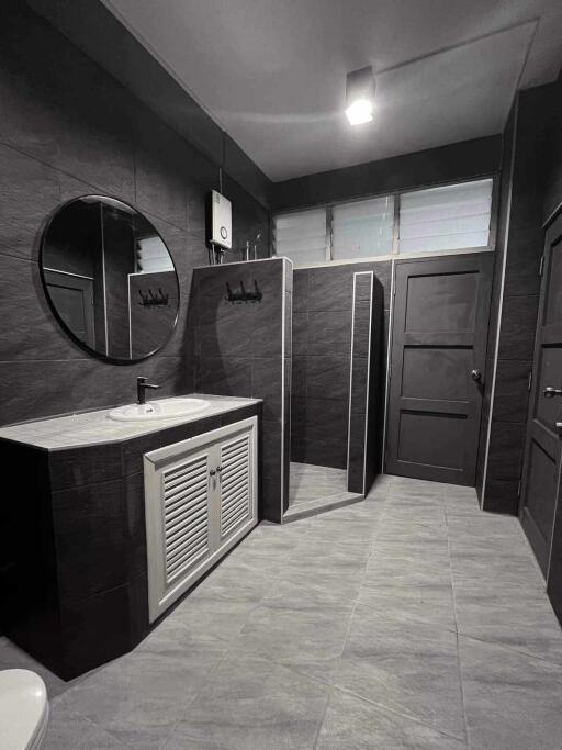 Modern black and white bathroom with spacious shower and vanity unit