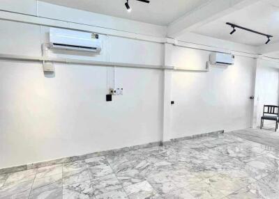 Spacious basement area with marble flooring and air conditioning units