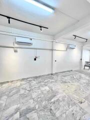 Spacious basement area with marble flooring and air conditioning units