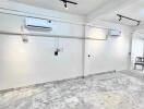 Spacious basement area with marble flooring and air conditioning units