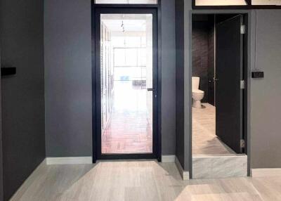 Interior corridor with view into bathroom and main living area