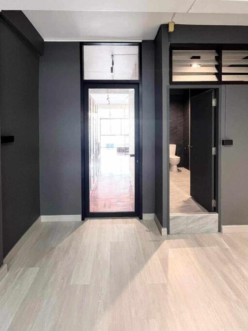 Interior corridor with view into bathroom and main living area