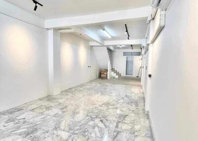 Spacious well-lit area with marble flooring