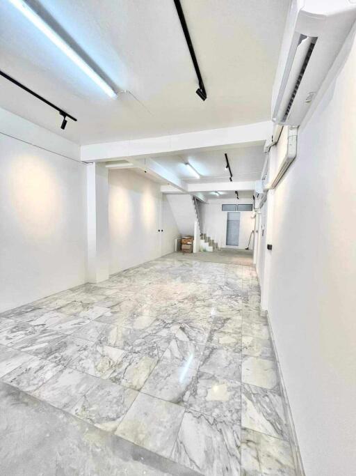 Spacious well-lit area with marble flooring