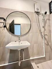 Bathroom with round mirror and shower