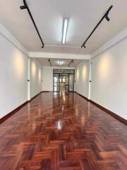 spacious room with wooden parquet flooring