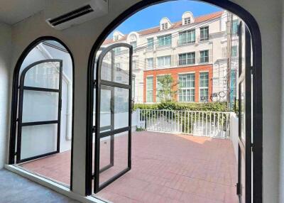 Bright living area with large arched windows and terrace