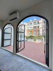 Bright living area with large arched windows and terrace