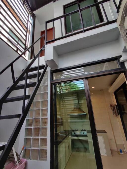 Interior view with a staircase and kitchen area