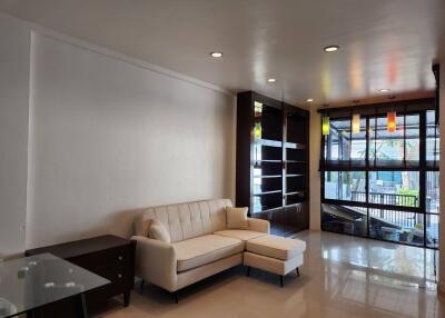 Modern living room with a white couch and glass table