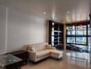 Modern living room with a white couch and glass table