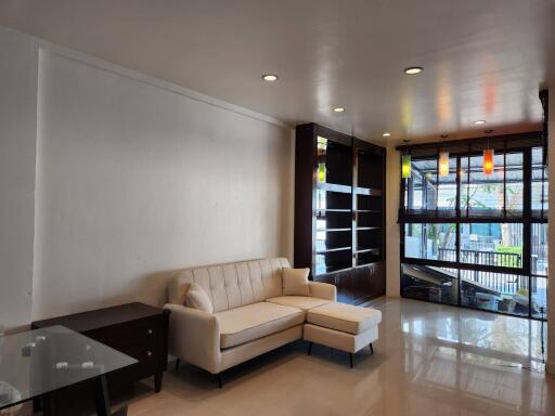 Modern living room with a white couch and glass table