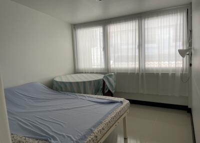 Bedroom with a bed, window, and round table