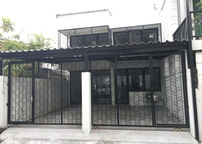 Exterior view of the building with metal gate and garage