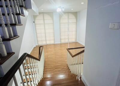 Staircase leading to a bright open space