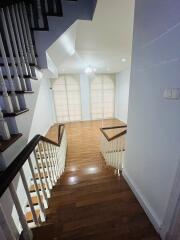 Staircase leading to a bright open space