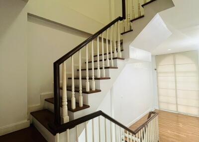 Staircase with wooden steps and white balusters