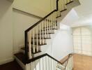 Staircase with wooden steps and white balusters