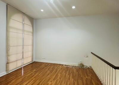 Unfurnished living room with hardwood flooring and a large window