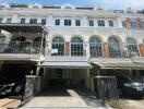 Front view of townhouse with multiple levels and carports