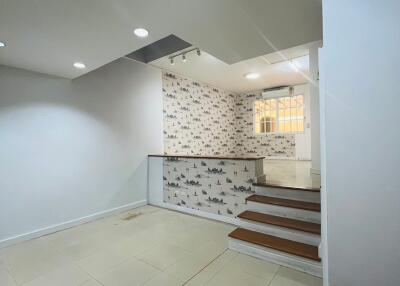 Interior view of main living area with staircase and decorative wall