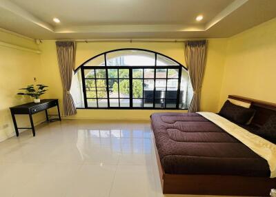 Spacious bedroom with large window and bed