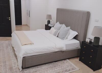 Well-furnished modern bedroom with a double bed, nightstands, and lamps