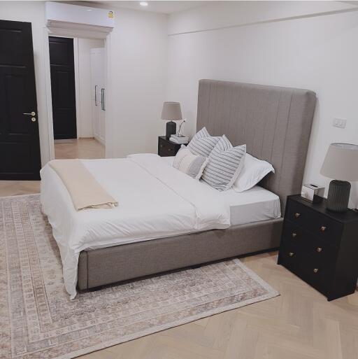 Well-furnished modern bedroom with a double bed, nightstands, and lamps