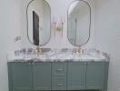 Modern bathroom with double vanity, marble countertop, and gold fixtures