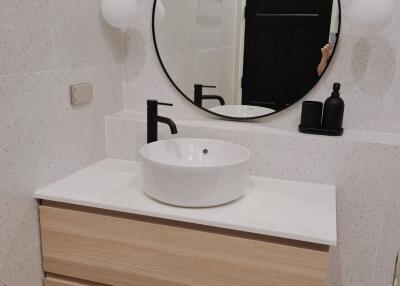 Modern bathroom with floating vanity and round mirror