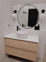 Modern bathroom with floating vanity and round mirror