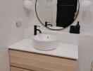 Modern bathroom with floating vanity and round mirror