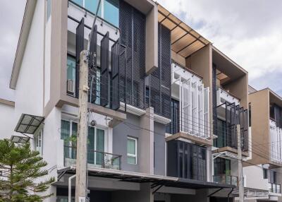 Modern multi-story building with balconies and large windows