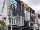 Modern multi-story building with balconies and large windows