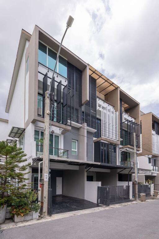 Modern multi-story building with balconies and large windows