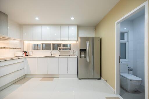 Modern kitchen with white cabinets and stainless steel appliances