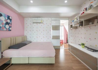 Spacious and well-decorated bedroom with modern furnishings and ample storage