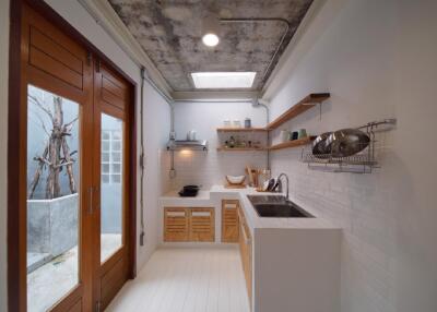 Modern kitchen with wooden accents and concrete ceiling