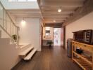 Modern hallway with a stairway and kitchen appliances.