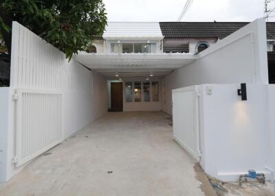 Exterior view of the building with a driveway and gates