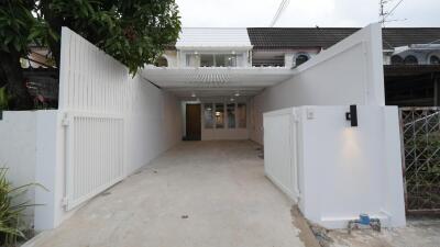 Exterior view of the building with a driveway and gates