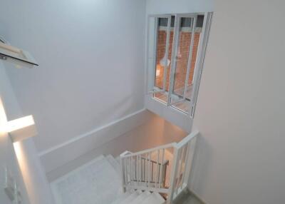 View of staircase with white walls and windows