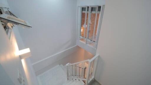 View of staircase with white walls and windows