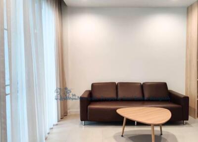 Living room with a brown sofa and a wooden coffee table